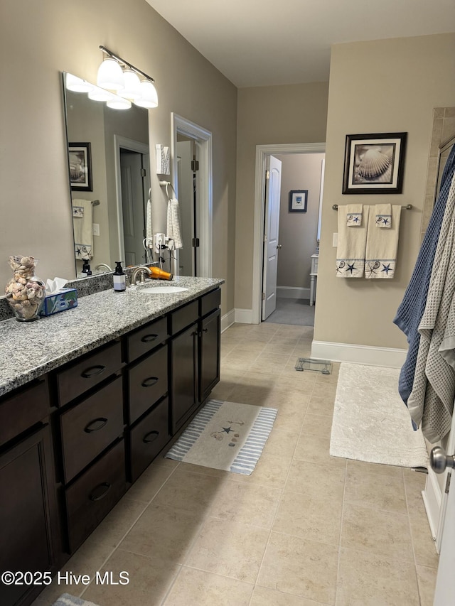 bathroom featuring tile patterned flooring and vanity