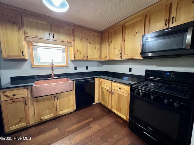 kitchen with sink, dark hardwood / wood-style floors, and black appliances