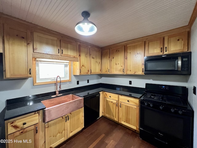 kitchen with sink, black appliances, and dark hardwood / wood-style floors