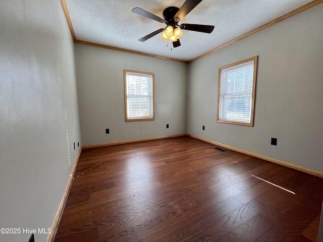 unfurnished room featuring ceiling fan, dark hardwood / wood-style floors, ornamental molding, and a textured ceiling