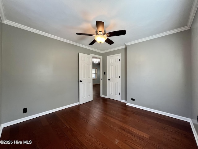 empty room with dark hardwood / wood-style flooring, ceiling fan, and ornamental molding