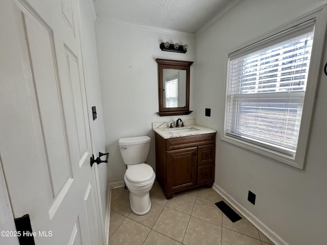 bathroom with a textured ceiling, tile patterned floors, and a wealth of natural light