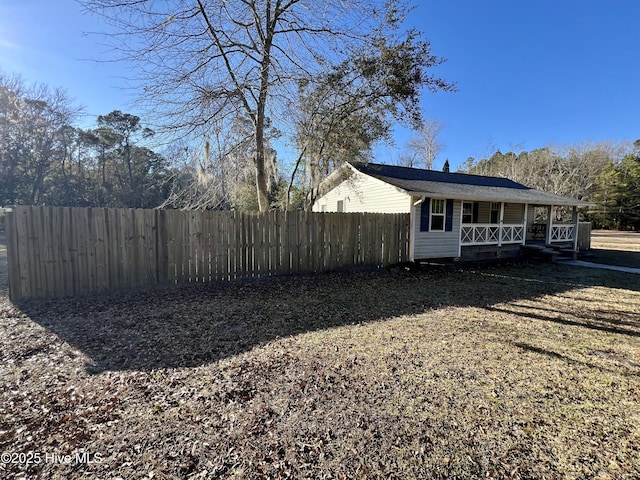 view of side of home with a porch