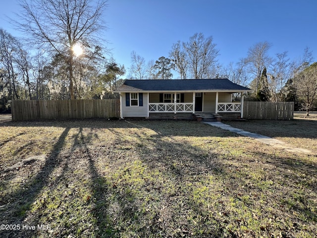 ranch-style house with a front yard and a porch