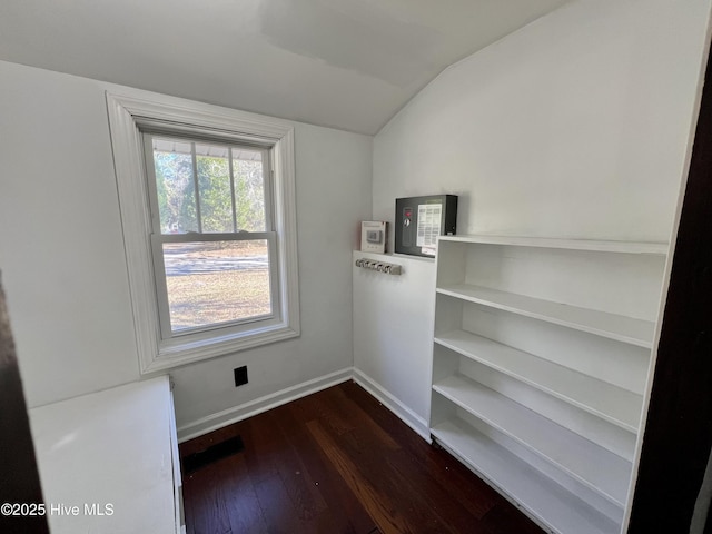 empty room featuring dark hardwood / wood-style flooring and vaulted ceiling