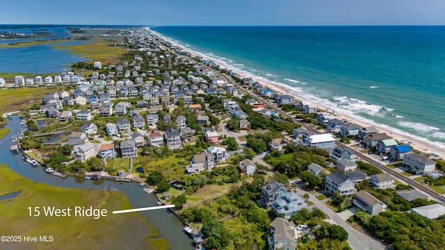 birds eye view of property with a beach view and a water view