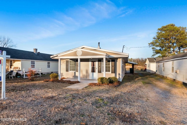 rear view of house with covered porch