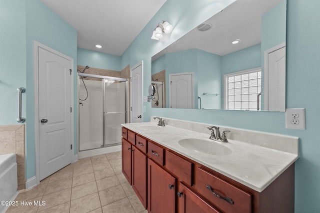 bathroom featuring shower with separate bathtub, vanity, and tile patterned floors