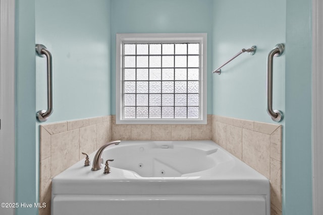 bathroom with plenty of natural light and a bathtub