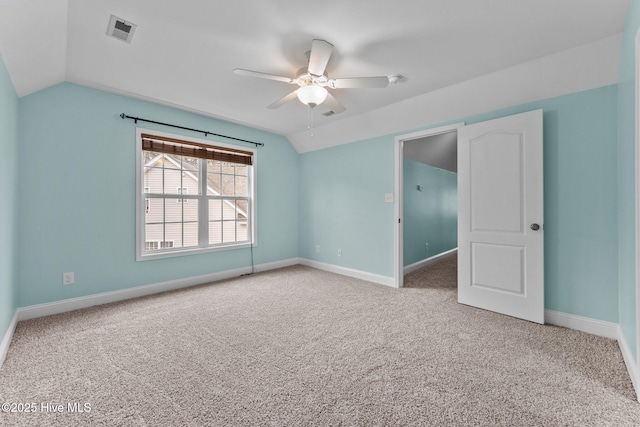 carpeted spare room featuring ceiling fan and lofted ceiling