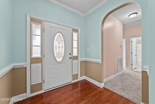 foyer entrance featuring hardwood / wood-style floors and crown molding