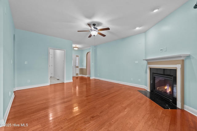 unfurnished living room featuring light hardwood / wood-style flooring and ceiling fan