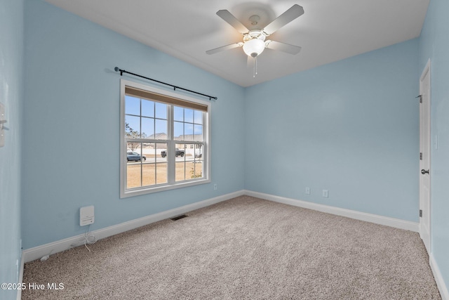 unfurnished room featuring ceiling fan and carpet floors