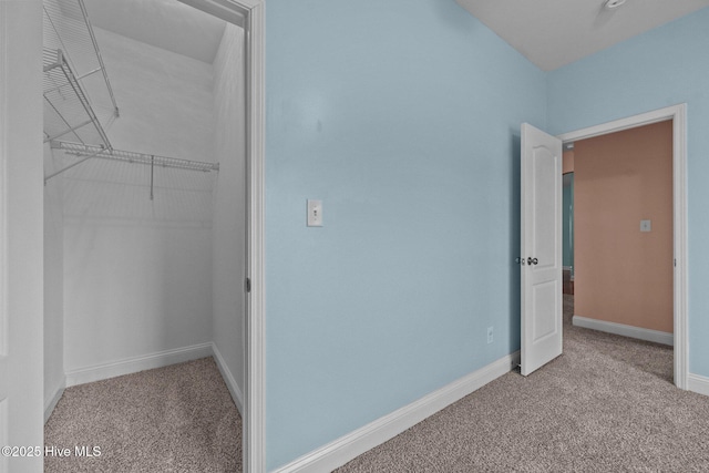 unfurnished bedroom with light carpet and a closet