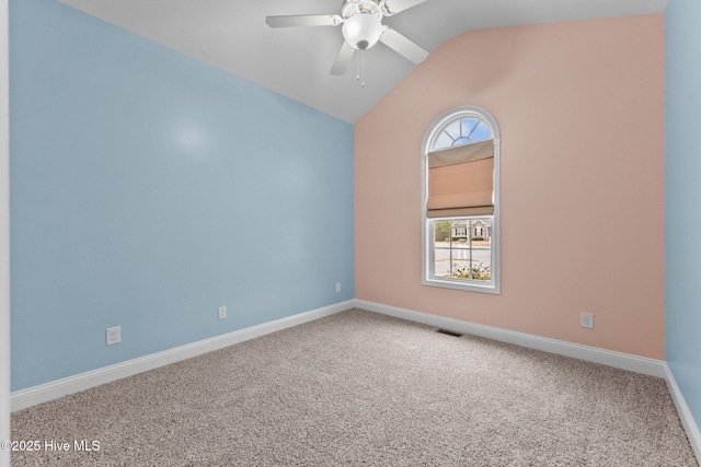 spare room with carpet, ceiling fan, and lofted ceiling