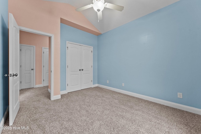 unfurnished bedroom with ceiling fan, light colored carpet, lofted ceiling, and a closet