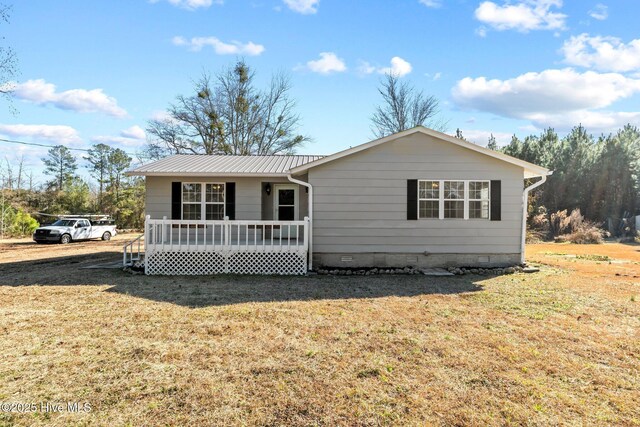 ranch-style home featuring a wooden deck and a lawn