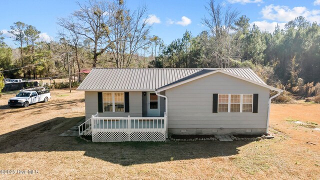 rear view of house featuring a deck and cooling unit