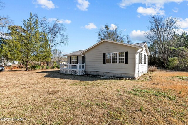 rear view of house with a yard, cooling unit, and a deck