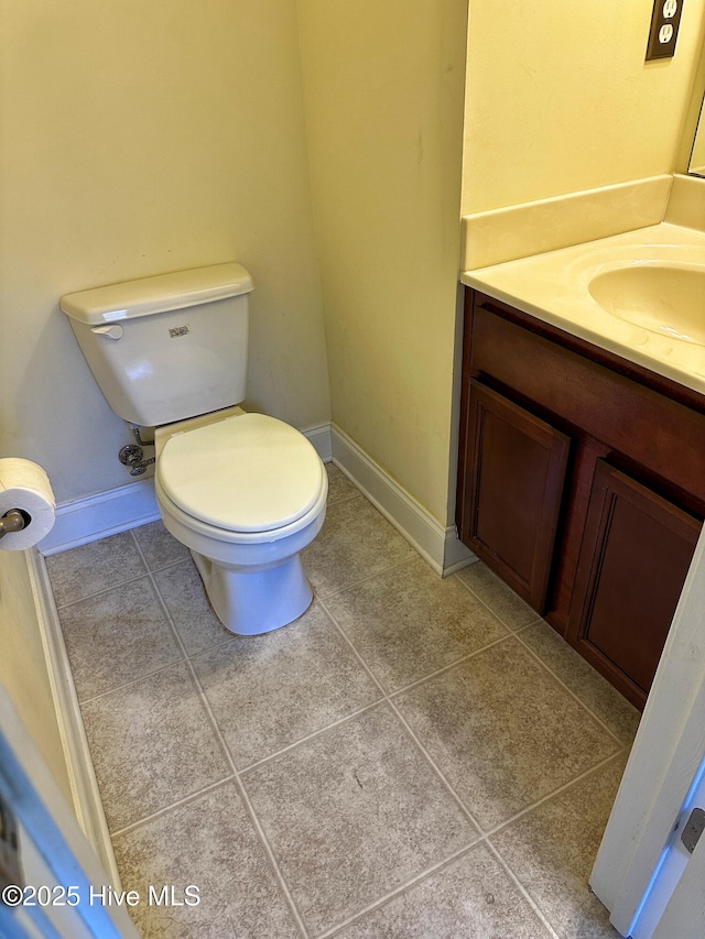 bathroom with tile patterned flooring, vanity, and toilet