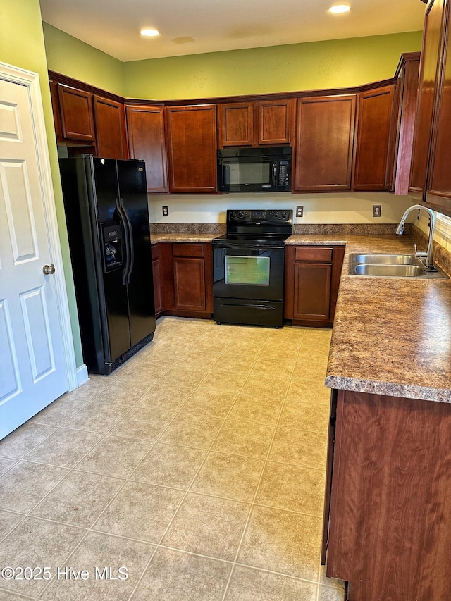 kitchen with black appliances, light tile patterned floors, and sink