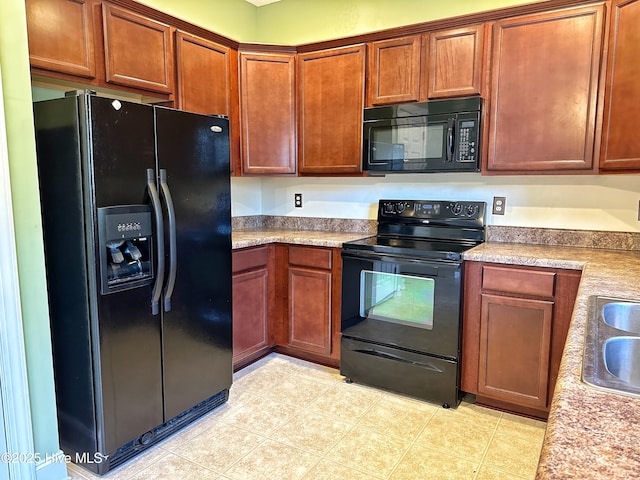 kitchen featuring black appliances and light tile patterned floors