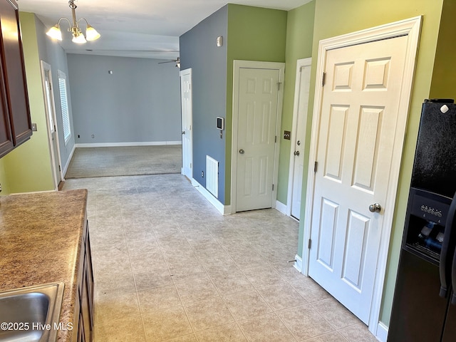 interior space featuring light tile patterned flooring, sink, and an inviting chandelier