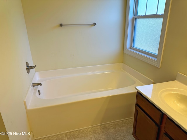 bathroom featuring vanity, tile patterned floors, and a bathtub