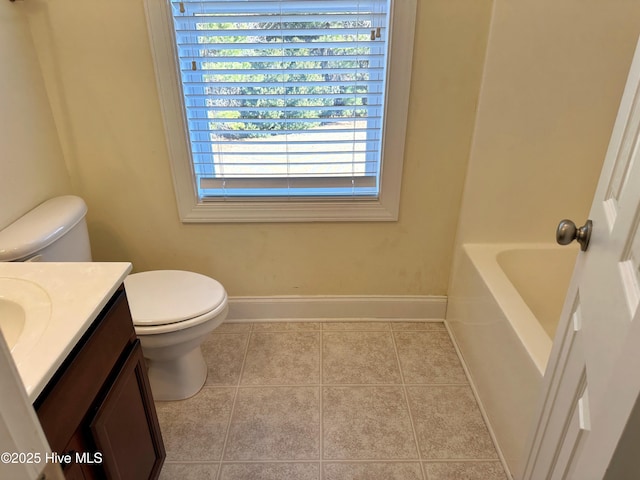 bathroom featuring tile patterned floors, vanity, plenty of natural light, and a tub