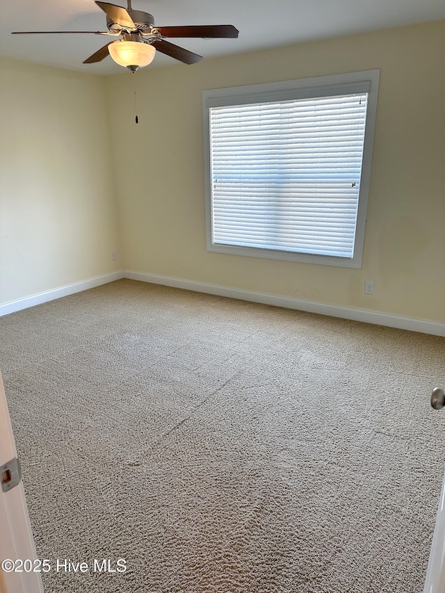 unfurnished room with carpet flooring and ceiling fan