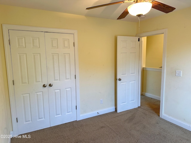 unfurnished bedroom featuring carpet flooring, ceiling fan, and a closet