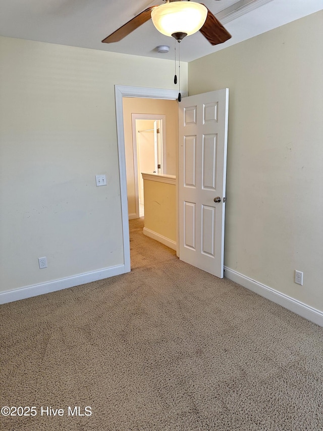 spare room featuring carpet flooring and ceiling fan