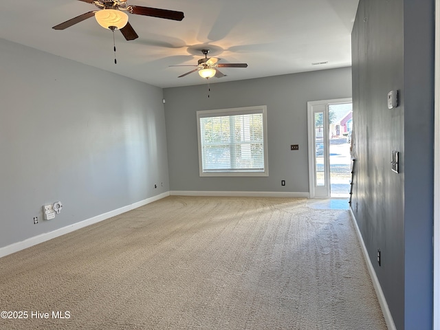 empty room featuring light colored carpet and ceiling fan