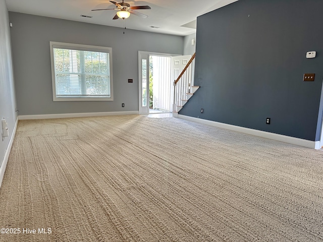 unfurnished living room featuring ceiling fan and carpet floors