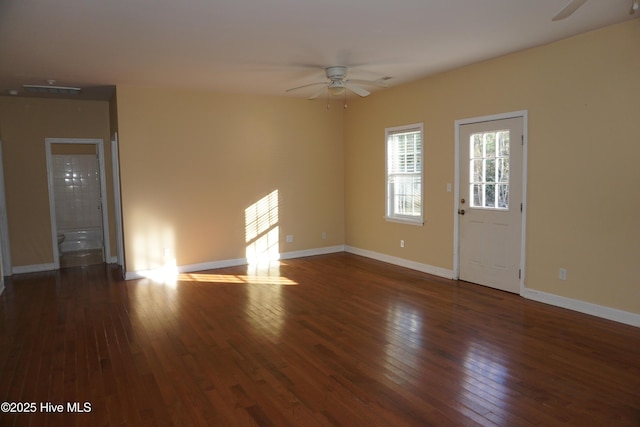 empty room featuring ceiling fan and dark wood-type flooring