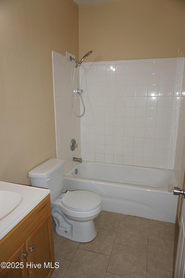 full bathroom featuring tile patterned flooring, vanity, toilet, and shower / tub combination