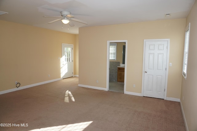 spare room featuring ceiling fan and light colored carpet