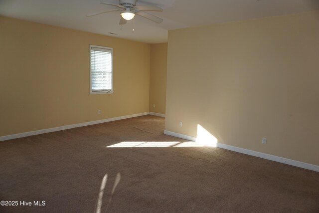 carpeted spare room featuring ceiling fan