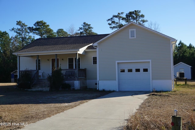 view of front of home with central AC, a porch, and a garage