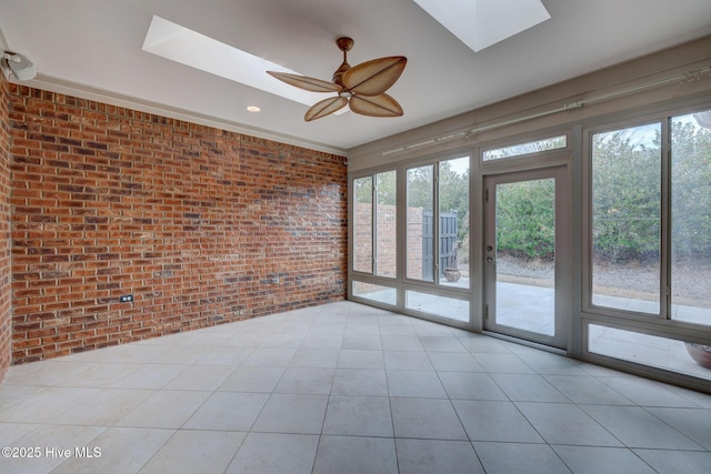 unfurnished sunroom featuring ceiling fan and a skylight