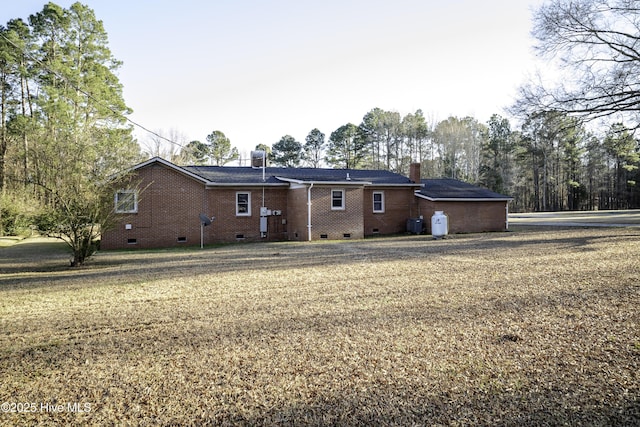 back of property with cooling unit and a yard