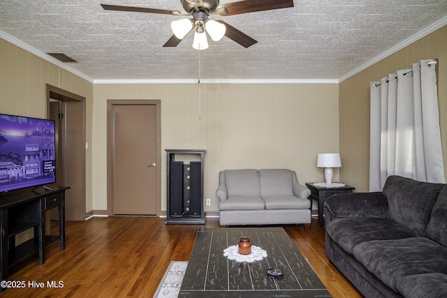 living room featuring ornamental molding, dark hardwood / wood-style floors, and ceiling fan