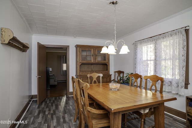 dining area with an inviting chandelier, ornamental molding, and dark hardwood / wood-style floors