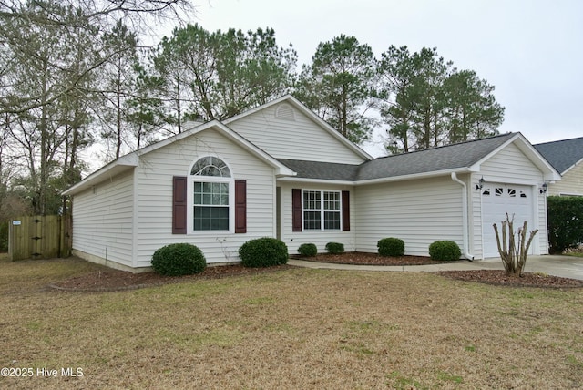 ranch-style home featuring a garage and a front lawn