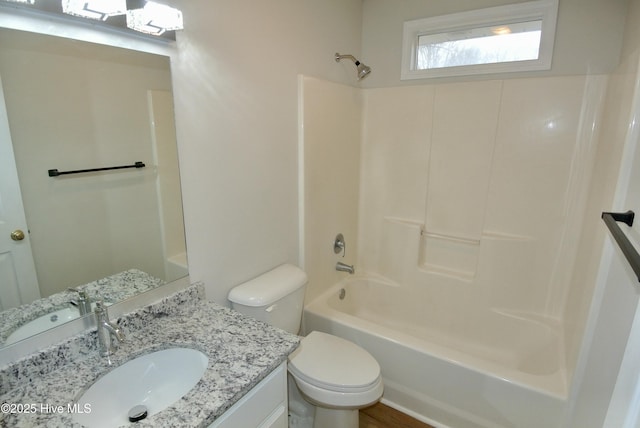 full bathroom with vanity, shower / bathtub combination, and toilet