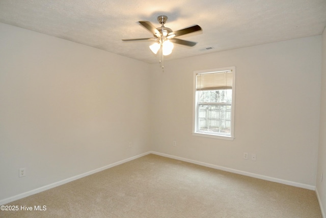 unfurnished room with ceiling fan, carpet floors, and a textured ceiling