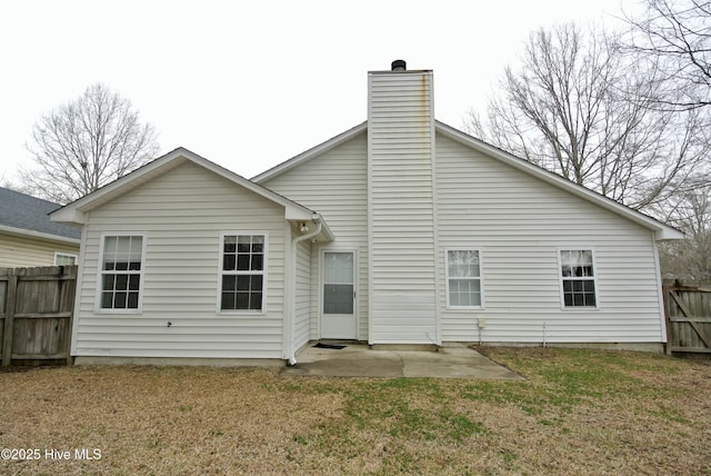 back of house featuring a yard and a patio