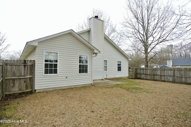 back of property featuring a lawn