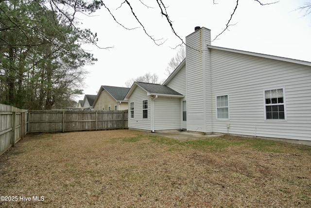 back of property featuring a lawn and a patio area