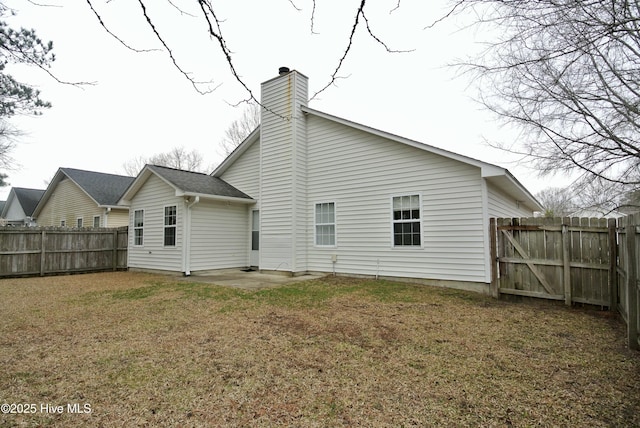 back of property with a patio and a lawn